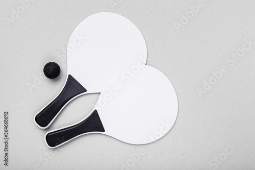 set for a game of beach tennis isolated on the white background wooden white racket pong