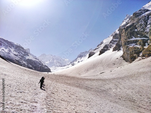 Manali, India - June 14th 2019: A group of friends/hikers climbing a narrow snowy/Glacial valley to reach the top of the Indian Himalayan Mountain Peak. Hampta Pass trek near Manali.