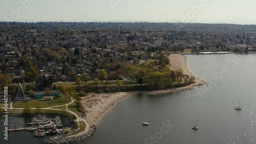 Aerial pan to left.  Pan up at end. Kitsilano, Maritime museum, planetarium, Granville Island. Vanier Park, False Creek south, Granville Bridge, Burrard Bridge, Sunset Beach. Vancouver BC Canada. photo