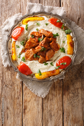 Alinazik kebab is a home-style Turkish dish which is a specialty of the Gaziantep province of Turkey closeup in the plate. vertical top view photo