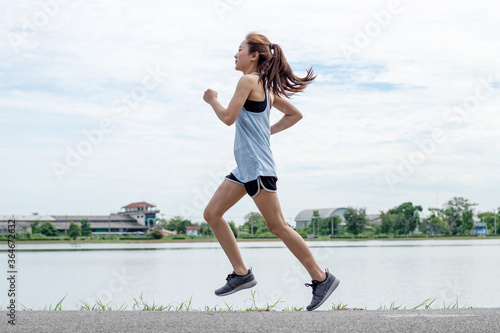 Asian Women Runners. She runs on the street.
