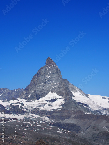 Matterhorn seen from the mountain climbed by the train in Zermatt on a sunny day.
