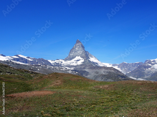 Matterhorn seen from the mountain climbed by the train in Zermatt on a sunny day.