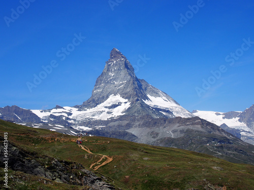 Matterhorn seen from the mountain climbed by the train in Zermatt on a sunny day.