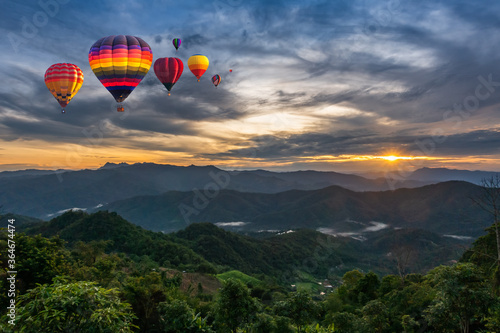 Colorful Hot Air Balloons over mountain in sunrise in forest, Chiang Mai in Thailand