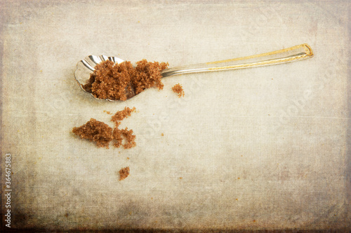 Pretty spoon with brown sugar.  Photo with texture layers. photo