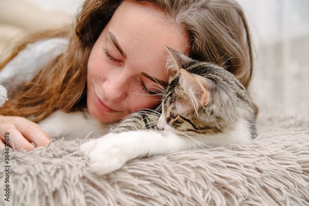 girl stroking a cat on the bed girl stroking a cat on the bed
