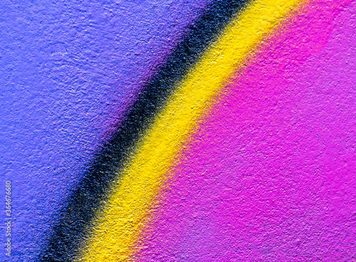 Beautiful bright colorful street art graffiti background. Abstract creative spray drawing fashion colors on the walls of the city. Urban Culture, yellow , pink , purple , crimson, blue texture