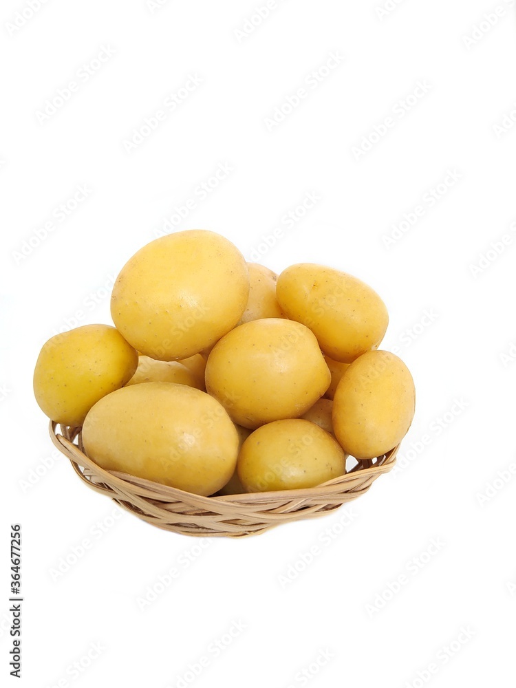 New potatoes in a straw bowl New potatoes in a straw bowl