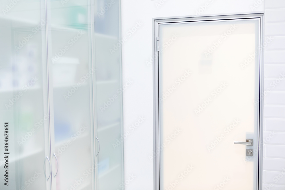 Fragment of a glass door and cabinet. White, frosted glass. Fragment of a glass door and cabinet. White, frosted glass.
