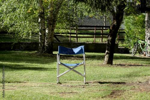 relax concept: empty chair in a garden at sunset with copy space for your text