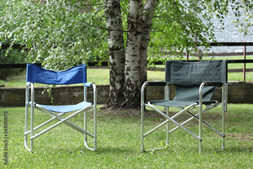 relax concept: two empty chairs in a garden at sunset with copy space for your text