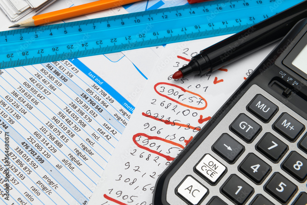 business office desk closeup - financial reports, analysis and accounting, set of documents, tables and graphs, various items for bookkeeping, calculator business office desk closeup - financial reports, analysis and accounting, set of documents, tables and graphs, various items for bookkeeping, calculator
