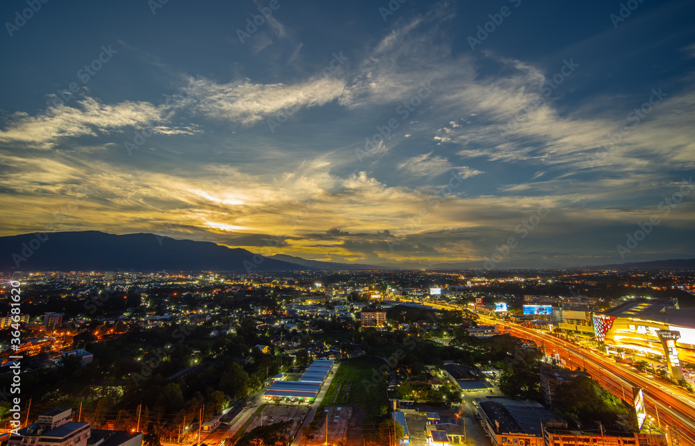 CHIANG MAI, THAILAND - JUNE 28, 2020 : Aerial night view of Chiang Mai Cityscape from a high angle with Doi Suthep and super highway at dusk in Chiang Mai, Thailand.