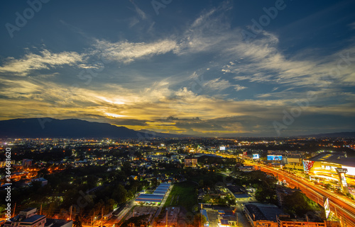 CHIANG MAI, THAILAND - JUNE 28, 2020 : Aerial night view of Chiang Mai Cityscape from a high angle with Doi Suthep and super highway at dusk in Chiang Mai, Thailand.