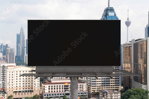 Photography Blank black road billboard with Kuala Lumpur cityscape background at day time