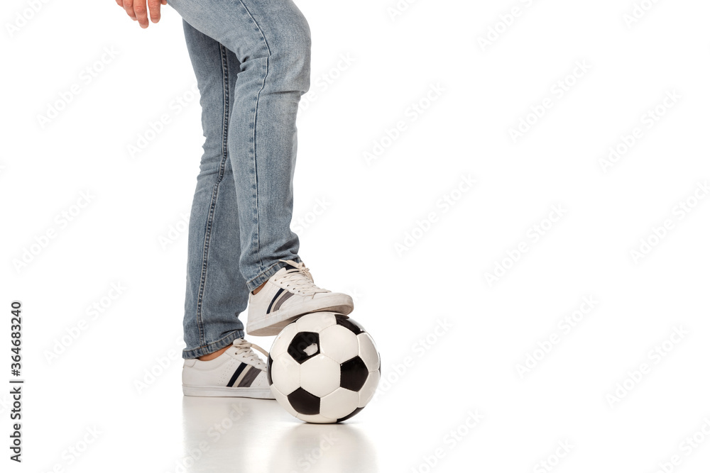 cropped view of man in jeans playing football on white cropped view of man in jeans playing football on white