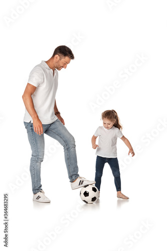 handsome father playing football with cute daughter on white