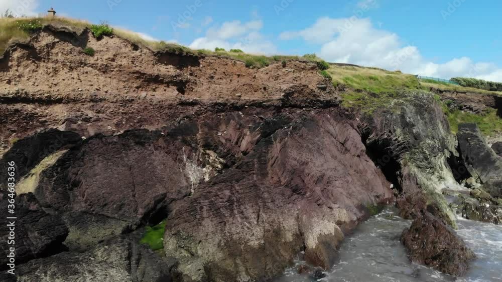 Rocky coastline, coastal cliff with house on the top Rocky coastline, coastal cliff with house on the top