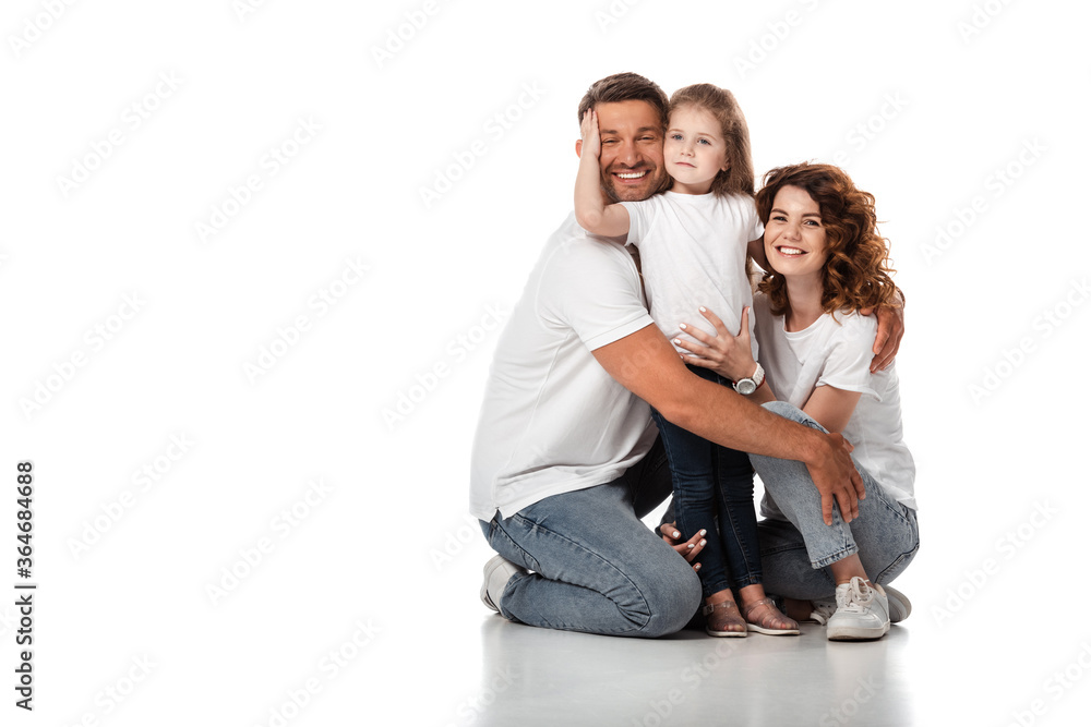 happy kid hugging father near cheerful mother on white happy kid hugging father near cheerful mother on white