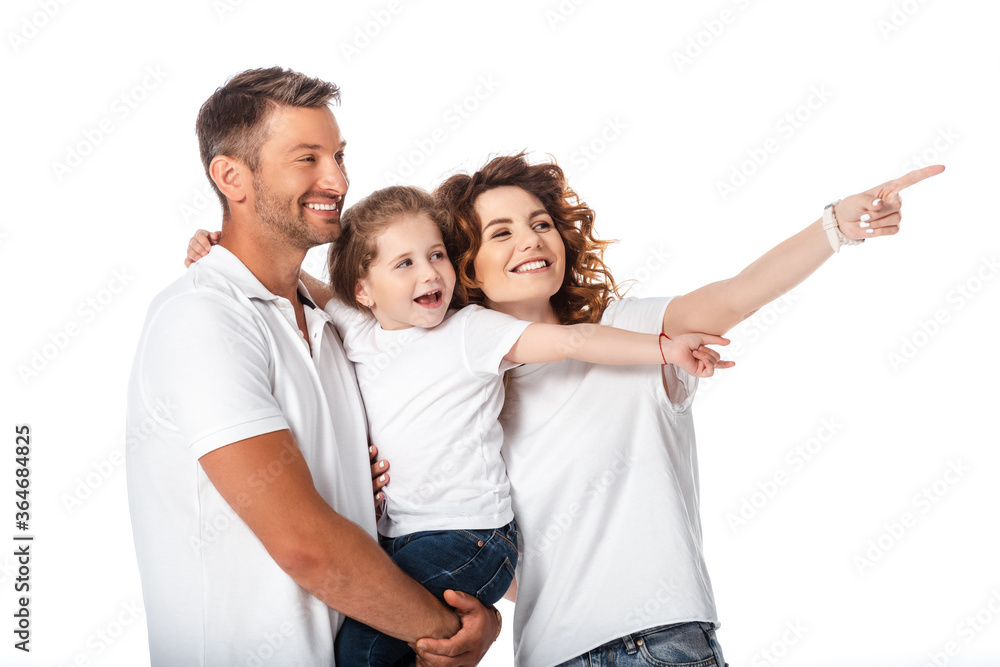happy mother pointing with finger near cheerful husband holding in arms kid isolated on white happy mother pointing with finger near cheerful husband holding in arms kid isolated on white