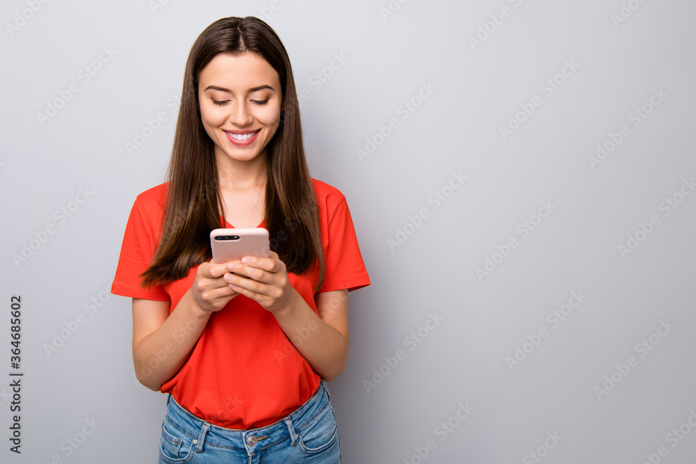 Portrait of her she nice attractive lovely cute cheerful cheery straight-haired girl holding in hands cell using wi-fi wireless connection isolated over light gray pastel color background