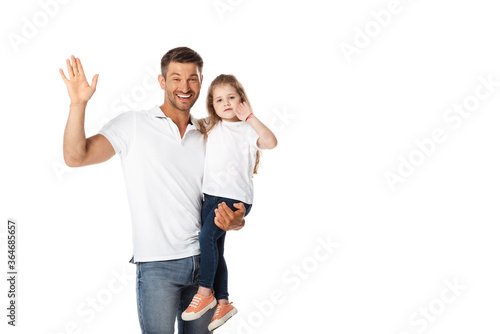 cheerful father holding in arms cute daughter and waving hand isolated on white