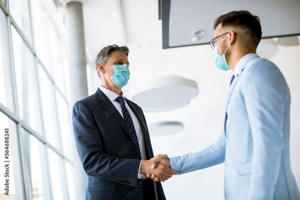 Two colleagues handshake when meeting in the office Two colleagues handshake when meeting in the office