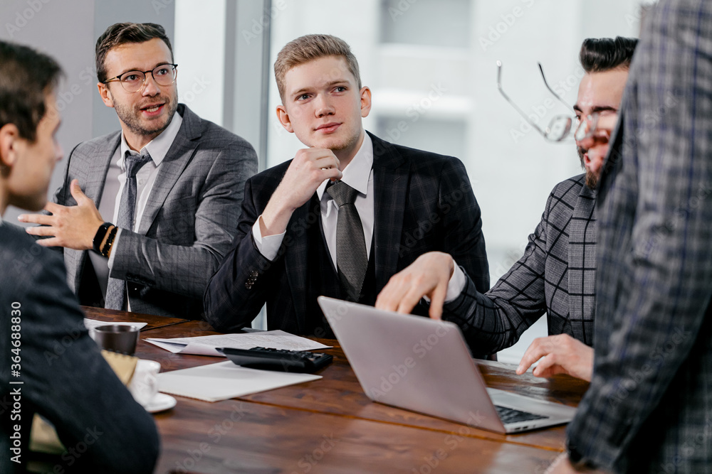 leadership and business concept. business team in modern office sit having active discussion of business ideas together, wearing tuxedo, formalwear leadership and business concept. business team in modern office sit having active discussion of business ideas together, wearing tuxedo, formalwear