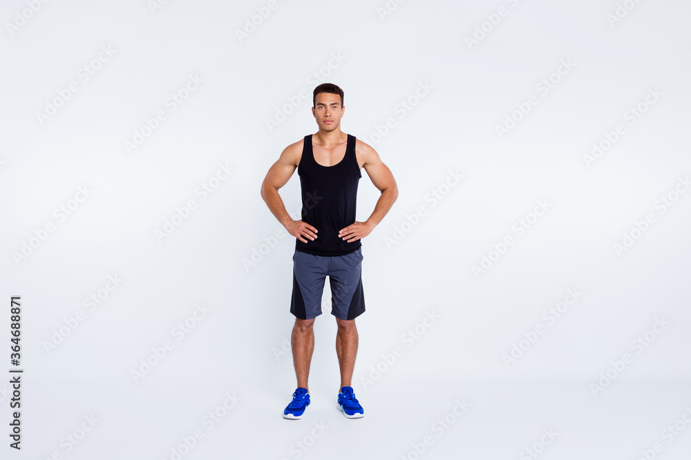 Full length body size view of his he nice attractive content serious sportive guy visiting gym self development hands on hips isolated over gray pastel color background