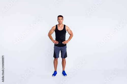 Full length body size view of his he nice attractive content serious sportive guy visiting gym self development hands on hips isolated over gray pastel color background