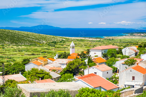 Old village of Kolan on the island of Pag in Dalmatia, Croatia, Adriatic seascape in background
