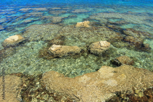 Clear blue sea on rocky beach near Rovinj, touristic destination in Croatia
