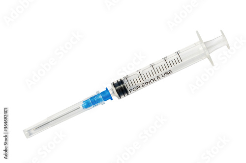 Plastic disposable syringe with protective cap isolated on white background