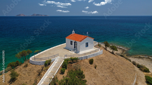 Aerial drone photo of famous seaside chapel of Agios Aimilianos in resort area, Porto Heli, Argolida, Peloponnese, Greece