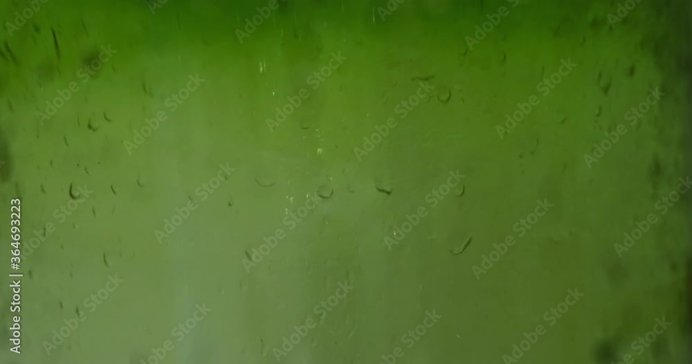Water drops on green glass, blurred background. Texture Water drops on green glass, blurred background. Texture