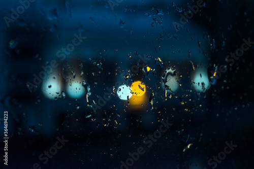 Fototapeta Naklejka Na Ścianę i Meble -  Texture of raindrops on glass at night