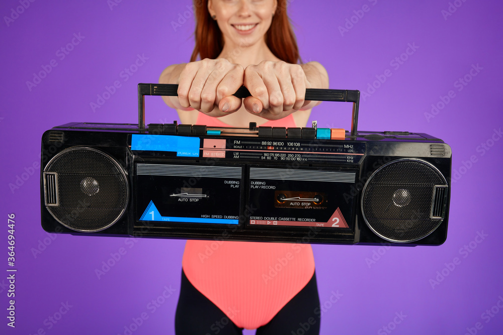 cropped shot of unrecognizable red-haired female model holding portable retro  radio cassette player, shooting in music video in retro 80s style, close up  on audio player foto de Stock | Adobe Stock