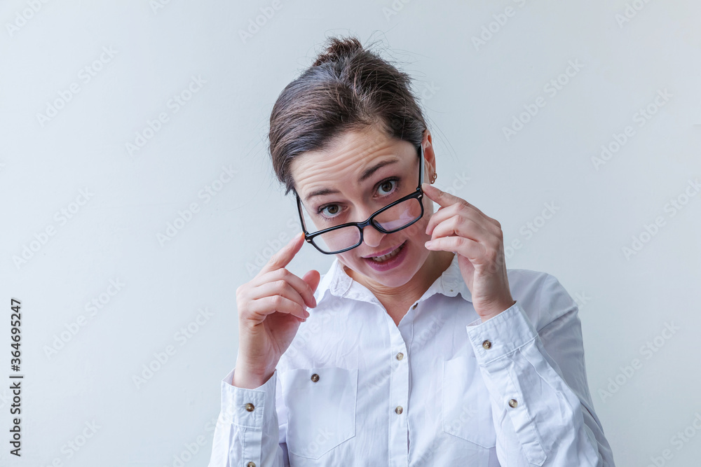 Beautiful happy girl smiling. Beauty simple portrait young smiling brunette woman in eyeglasses isolated on white background. Positive human emotion facial expression body language. Copy space Beautiful happy girl smiling. Beauty simple portrait young smiling brunette woman in eyeglasses isolated on white background. Positive human emotion facial expression body language. Copy space