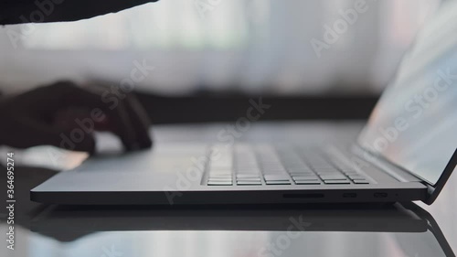 Close-up of man hands typing on laptop keyboard. Businessman writing business letter. Man closing laptop with one hand. 4K, UHD