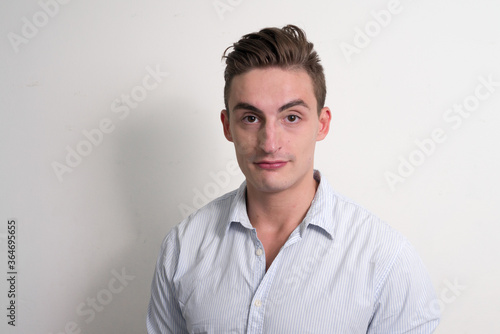 Portrait of young handsome businessman looking at camera © Ranta Images