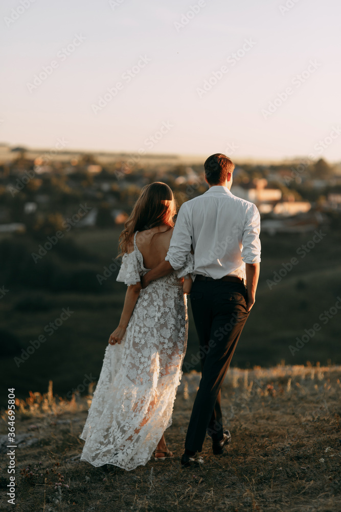 Beautiful wedding couple in nature in boho style. Wedding in the European style of fineart at sunset. Beautiful wedding couple in nature in boho style. Wedding in the European style of fineart at sunset.