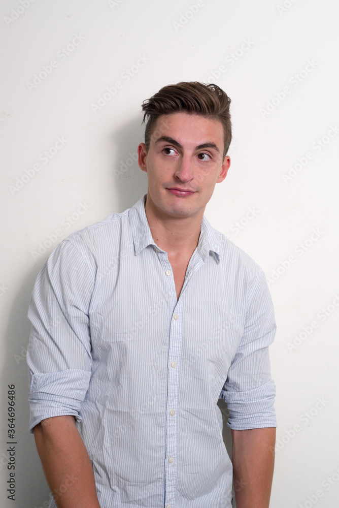 Portrait of young handsome businessman thinking and looking up Portrait of young handsome businessman thinking and looking up
