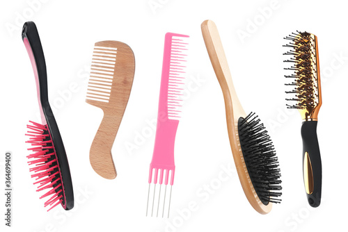 Set with different hair brushes and combs on white background