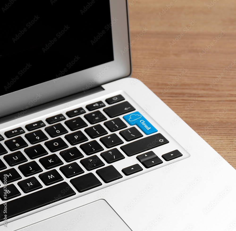 Cloud technology. Modern laptop on wooden table, closeup Cloud technology. Modern laptop on wooden table, closeup
