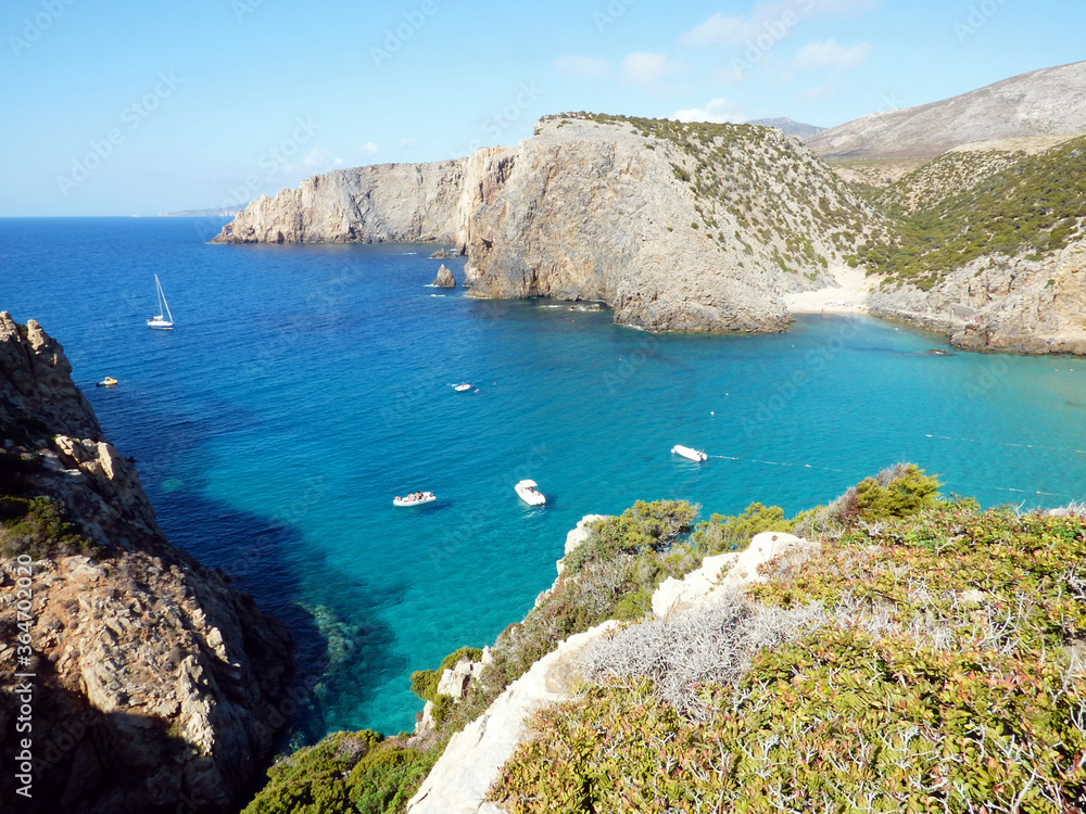 Fototapeta premium Cala Domestica, view of the bay from above along a path, some boats are moored
