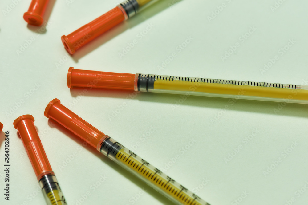 Close up of insulin syringes for diabetes lying in a circle isolated over light background. Injection medicine concept Close up of insulin syringes for diabetes lying in a circle isolated over light background. Injection medicine concept