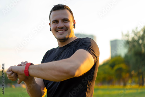 Technology for sport and active living. Athlete man talking into smartwatch wearable tech device speaking to someone or dictating message on smart watch app.