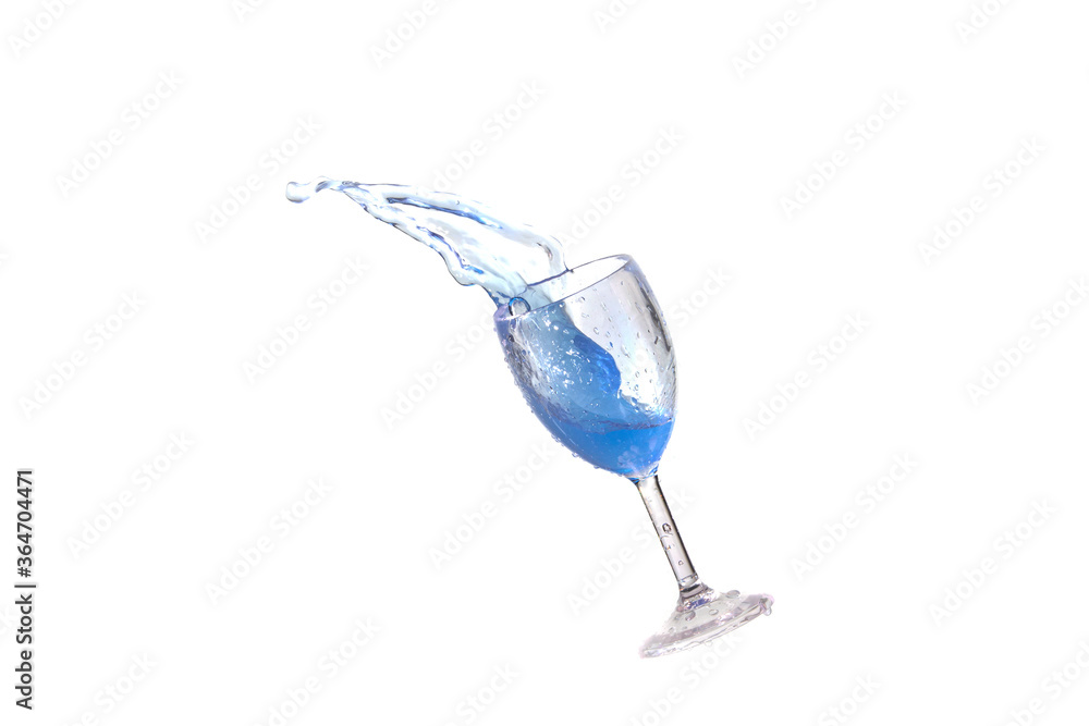 Blue splash water out of a glass on a white background. Blue splash water out of a glass on a white background.