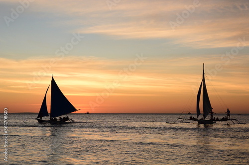 Sailing boats silhouette at sunset. Boracay island. Western Visayas. Philippines